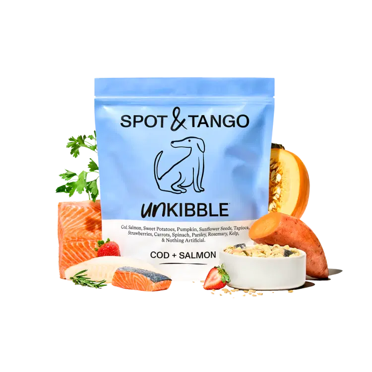 A bag of Cod and Salmon UnKibble surrounded by salmon, cod, pumpkin, and other fresh produce